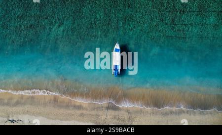 Idyllic beach in Indonesia with moored boats, seen from above Stock Photo