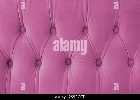Capitone, diamond checkered soft fabric textile decorative background with buttons. Classic retro Chesterfield style, luxurious upholstery pink textur Stock Photo