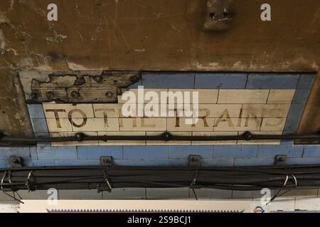 The original tiling and train sign of the abandoned Dover Street (Green Park) station in London Stock Photo