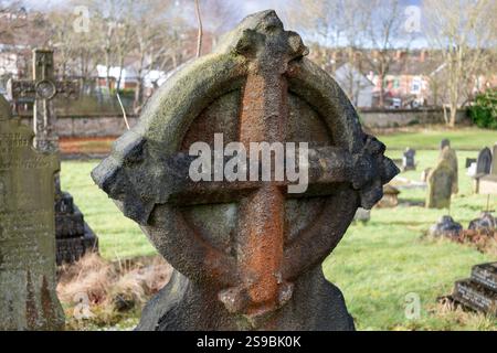 Victorian gravestone with a stone cross carving at Blackburn Cemetery. Stock Photo