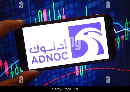 In this photo illustration, the Abu Dhabi National Oil Company logo is seen displayed on a smartphone screen. Stock Photo