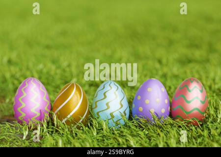 Colorful Easter eggs arranged on green grass, celebrating of the holiday. 3d rendering Stock Photo
