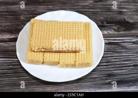 layers of wafer biscuits filled with creamy vanilla, a wafer is a crisp, sweet, very thin, flat, light biscuit,  creamy vanilla sandwiched in wafers, Stock Photo