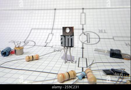 Circuit elements scattered on an electronic circuit diagram. Focused on transistor. Electronic projects concept. Stock Photo