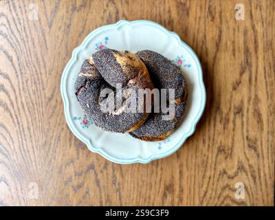 Acma pogaca buns with poppy seeds with olive paste in plate on wooden table Stock Photo