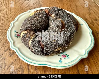 Acma pogaca buns with poppy seeds with olive paste in plate on wooden table Stock Photo