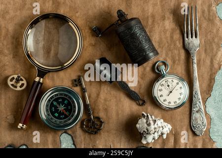 Vintage still life with compass, stopwatch, key, magnifying glass and seashell Stock Photo