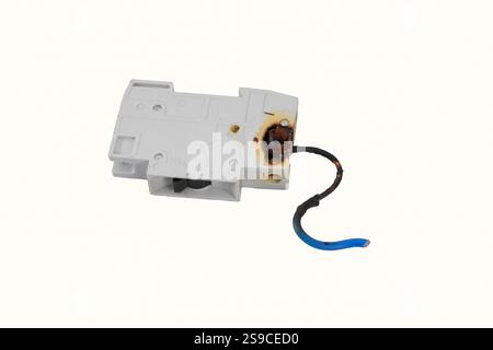 Burned electrical circuit breaker, fuse box on white background.  The burned cable Stock Photo