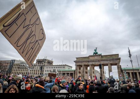 A protester holds a sign reading 