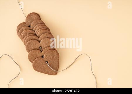 Heart shaped cookies on cream background with copy space. Minimal love layout. Creative biscuits idea. Yummy sweet food backdrop. Valentines day idea. Stock Photo