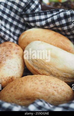 Freshly Baked Artisan Bread Rolls Presented in a Decorative Basket Stock Photo