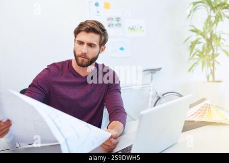 Architect, laptop and man with blueprint in office for building layout strategy, project development or renovation vision. Architecture, employee or Stock Photo