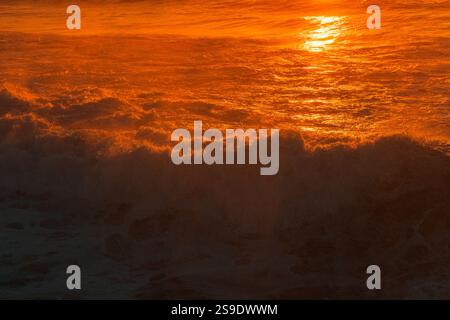 Texture of the water surface wave against a colorful Purple and Orange reflection color on the Atlantic Ocean Stock Photo