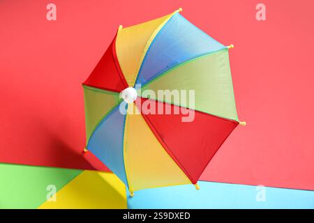 Colorful mini umbrella on color background Stock Photo