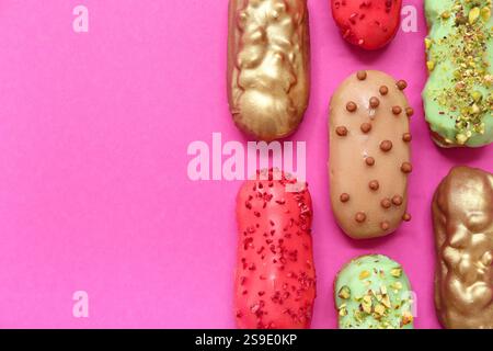 Composition with tasty glazed eclairs on pink background Stock Photo