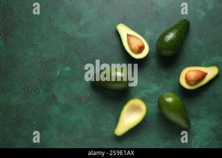 Frame made of fresh ripe avocados on green background Stock Photo