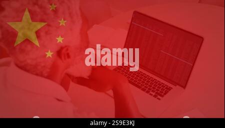 Chinese flag image over person working on laptop with data on screen Stock Photo