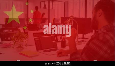 Chinese flag image over office workers using computers and collaborating Stock Photo