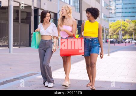 Three Happy Women Shopping and Strolling Outdoors. Stock Photo
