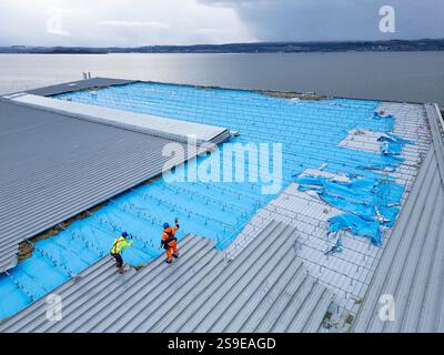 Helensburgh  25th January, 2025.  Aerial views as workers clear up debris blown from roof of the Helensburgh Leisure Centre by Storm Eowyn Stock Photo