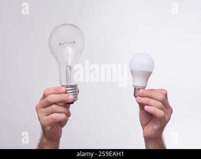 light bulbs in the hands on a white background. the concept of energy saving Stock Photo