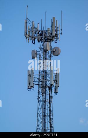 Telecommunications tower, modern technology infrastructure, transmission and broadcast, society connectivity, information overload saturation Stock Photo