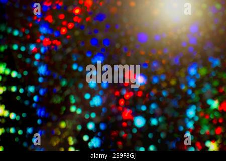 Vibrant Light Symphony with sun flare, dark background, led lights in bokeh. Stock Photo