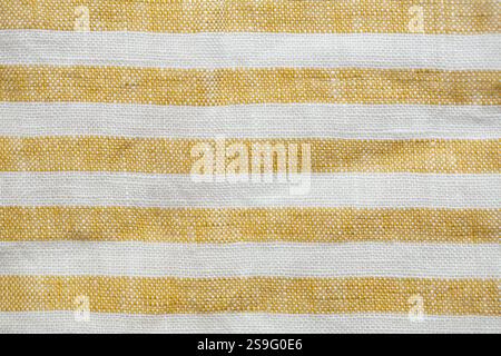 Yellow and white striped fabric with a rustic, woven texture. A seamless, natural pattern ideal for backgrounds, textiles, or decorative designs Stock Photo