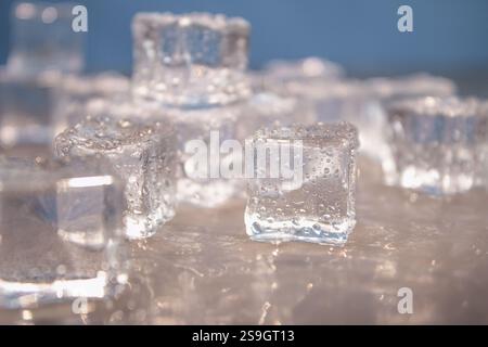 Ice cubes, Close-up. Water drops and splashes. Cool drink, alcohol, copy space. Stock Photo