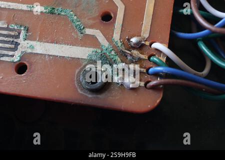 Copper lines with oxidized layer that appears green in color on the electronic circuit. Selected focus. Stock Photo