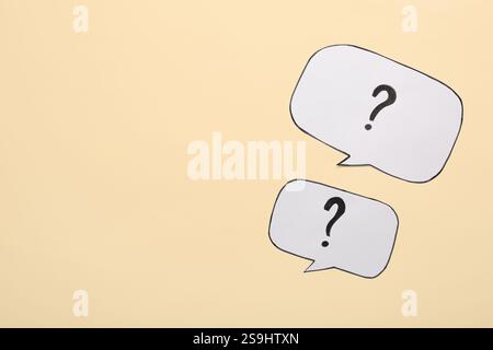 Speech bubbles with question marks on color background Stock Photo