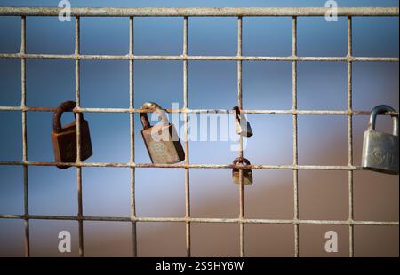 Memorial padlocks attached to railings on the beachfront at Seaford, East Sussex, UK Picture by Jim Holden Stock Photo