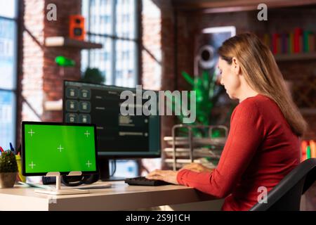 Freelancer uses AI assistant to generate solutions for tasks next to mockup, remote work at home office. Exemplifying smart automation and seamless connectivity for productivity online. Stock Photo