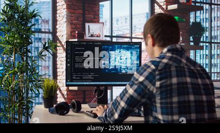 Developer writing code on computer and doing maintenance on artificial intelligence neural networks computerized model. Tech support expert typing on keyboard, doing checkup on AI systems, camera A Stock Photo