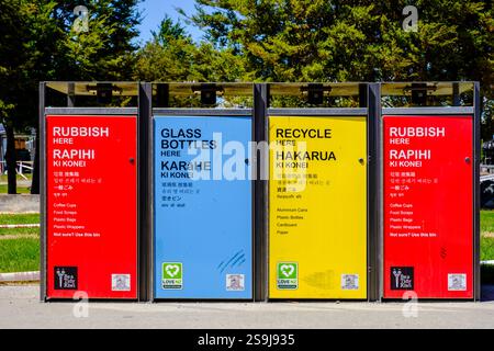 Red, blue, yellow colourful urban rubbish, garbage and recycling bins, containers at town of Twizel, New Zealand South Island, NZ Stock Photo