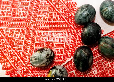 Hibiscus and onion dyed Easter eggs on embroidered towel.  Ukrainian traditions. Various embroidery techniques.  Preparation for Easter celebration Stock Photo