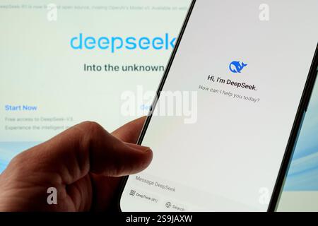 DeepSeek AI Assistant app seen on the smartphone and the company website on the blurred background. Stafford, United Kingdom, January 26, 2025 Stock Photo