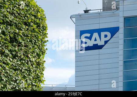 SAP SE logo prominently displayed on modern corporate headquarters facade, SAP corporate campus, symbolizing global software industry leadership, Wall Stock Photo