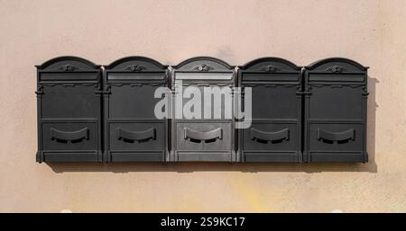 Private mailboxes hanging on old wall Stock Photo