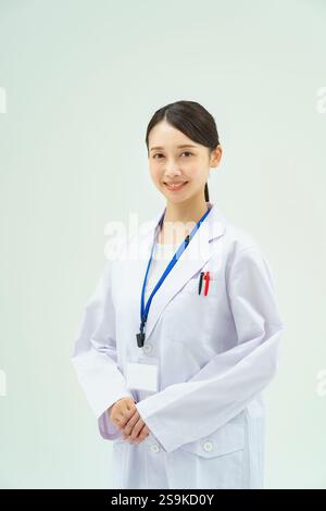 Woman in white coat Stock Photo - Alamy