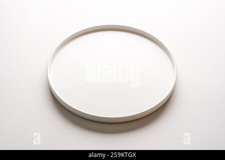 Top view of empty ceramic white plate on white background Stock Photo