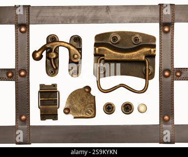 Details of the leather and bronze trim on retro trunk. Vintage chest decor set. Collection of belt, metal button and rivets, hinge, metallic decorativ Stock Photo