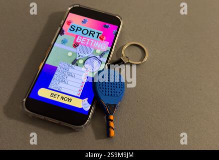 Sports betting website in a mobile phone screen, padel racket. High quality photo Stock Photo