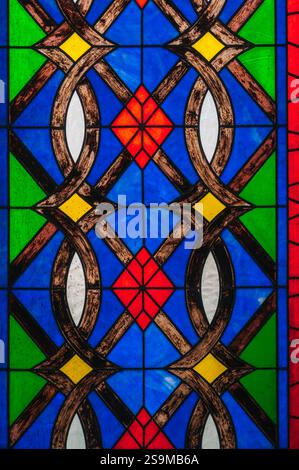 A detail of a multi-colored panel from a stained glass window in a Catholic church Stock Photo