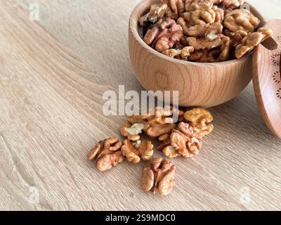 Walnuts kernels on dark desk with color background, Whole walnut in wood vintage bowl. High quality photo Stock Photo