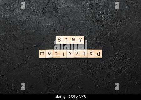 Stay motivated word written on wood block. Stay motivated text on cement table for your desing, concept. Stock Photo