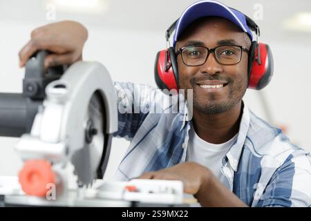 apprentice using circular saw in carpentry workshop Stock Photo