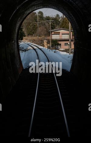 A view from the rear of a train entering a tunnel on the Tarumi Railway in Gifu Prefecture, Japan. Stock Photo