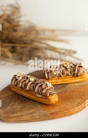 Eclairs with hazelnut coffee cream cheese filling and decor Stock Photo