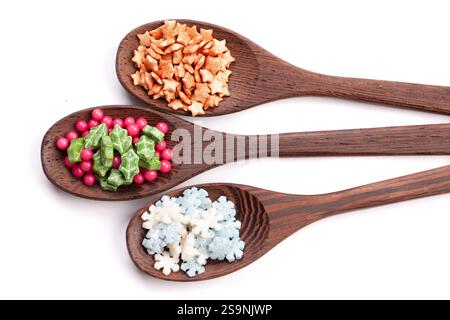 Wooden spoons with christmas cake sprinkles on isolated on a white background. space for text Stock Photo